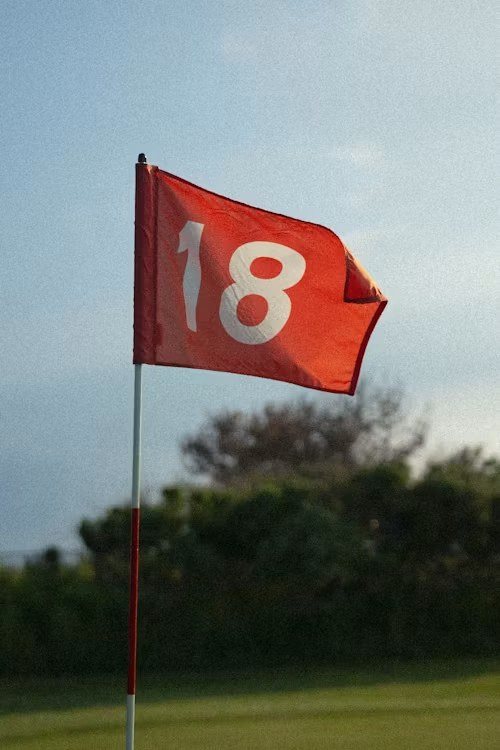 A red flag marked 18 on a green